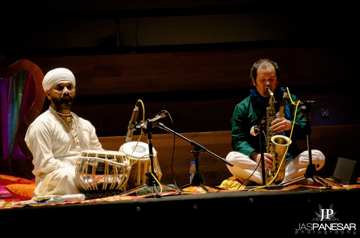 Jesse in green silk shirt playing the saxophone playing with Ustad Sukhwinder Singh Namdhari