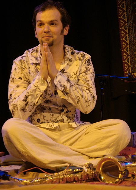  Jesse in Beige in yellow lighting and a black background.